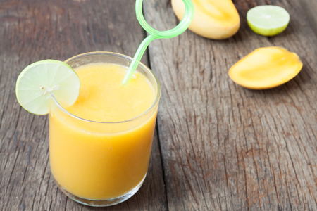 Close up mango smoothie on rustic wooden table, Summer conceptの写真素材