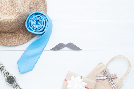 Happy Father's day, Man's accessories and gift bag on white wooden background, Holiday conceptの写真素材