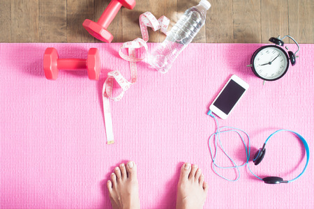 Selfie of feet healthy woman with yoga mat, sport equipments and smartphone, Healthy lifestyle conceptの写真素材