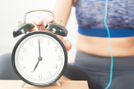 Sporty woman with alarm clock, Start up, Healthy concept 