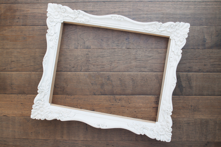 Vintage style white picture frame on wooden wall, Blank for copy spaceの写真素材