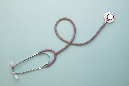 Flat lay of stethoscope on blue colour backgroundの写真素材