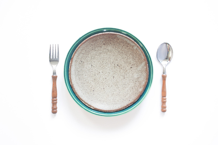 Ceramic plate with fork and spoon, Country style table set isolated on white backgroundの写真素材