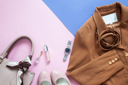 Flat lay working woman's accessories on pink and purple color backgroundの写真素材