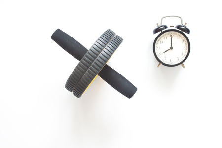 Abdominal muscle equipments and alarm clock on white background. Top view healthy lifestyle.の写真素材