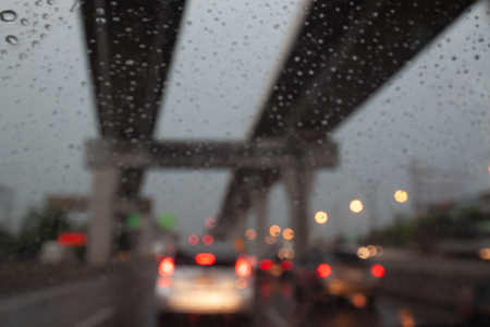 Blurred background view from car, rain drop on car window with traffic jam outsideの写真素材
