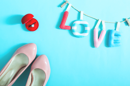 Engagement ring and bride's accessories on blue color background, Top view. Love conceptの写真素材