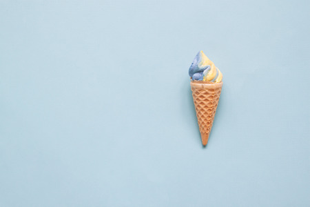 Pastel meringue cone on blue backgroundの写真素材