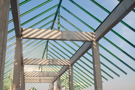 Structure of steel and concrete for building construction on blue sky background.の写真素材