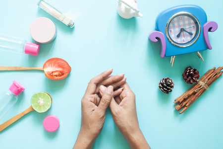 Woman's hands with cosmetic container and natural beauty ingredients. Skincare and Healthcare. Top viewの写真素材