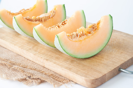 Fresh melons sliced on wooden cutting board. Healthy fruit, Summerの写真素材