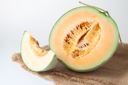 Half and sliced orange melons on white background. Healthy fruitの写真素材