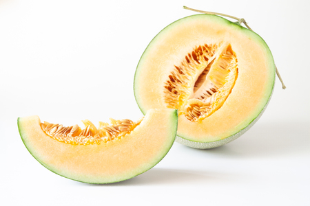 Half and sliced Japanese melons isolated on white backgroundの写真素材