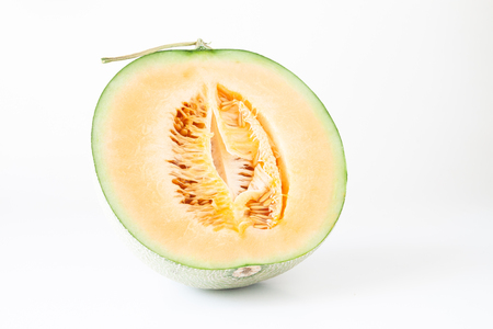 A half orange melon or Japanese melon on white backgroundの写真素材