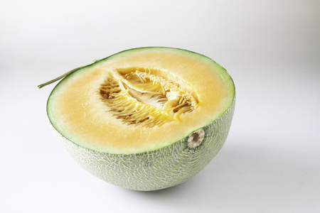 A half of orange Melon isolated on white backgroundの写真素材