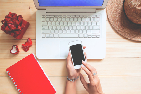 Top view woman using smart phone and laptop. Valentine's Day or lifestyle conceptの写真素材