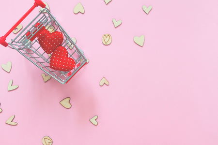 Hearts in shopping cart trolley on pink backgroundの写真素材