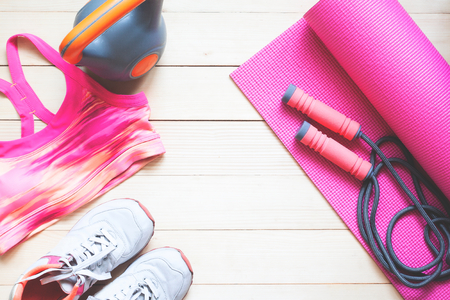Creative flat lay healthy and dieting concept. Fitness equipments and cloting in pink colour toneの写真素材