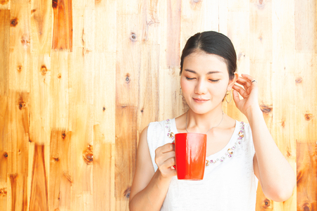 Young and beautiful asian woman holding red cup. Happy and Healthy peopleの写真素材