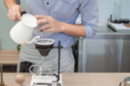 Barista pouring drip coffee, blurred background or defocusの写真素材
