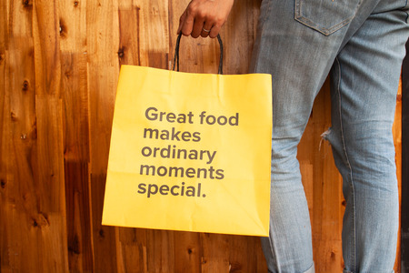 Great food makes ordinary moments special. Wording on yellow bag. Healthy woman or health day conceptの写真素材