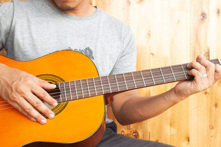 Close up asian man playing guitarの写真素材