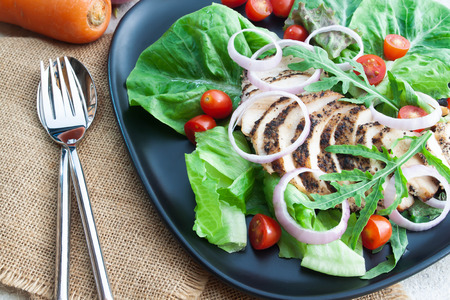 Healthy food, grilled chicken black pepper salad on concrete table. Dieting or kitchen conceptの写真素材