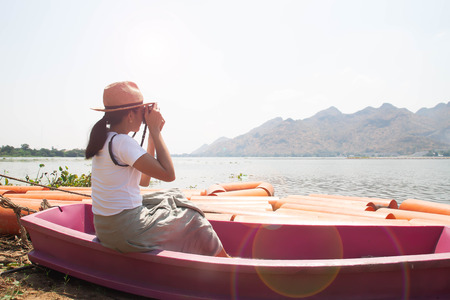 Happy traveler. Asian woman shooting photo of nature in summertimeの写真素材