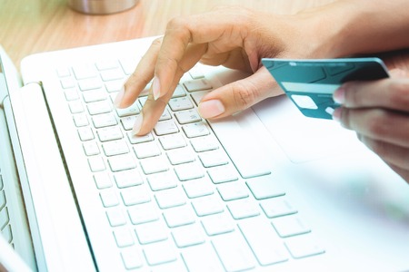 Woman holding credit card on laptop. Online shopping, Online banking conceptの写真素材