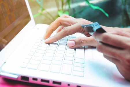 Woman holding credit card on laptop. Online shopping, Online banking conceptの写真素材