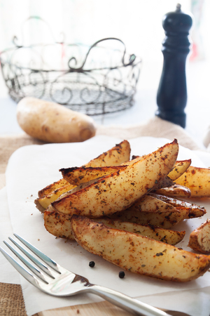 Baked potato wedges - homemade organic vegetable, vegan potato wedges snackの写真素材