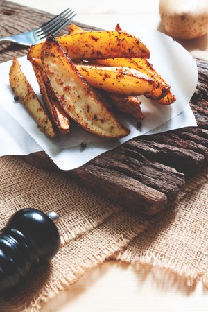Baked potatoes served on rustic wooden board. Vegan food or snack. Healthy foodの写真素材