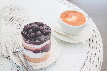 Blueberries short cake with a cup of hot americano on vintage style table. Lifestyle conceptの写真素材