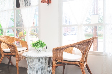 Vintage style furniture made from rattan in cafe. Decorated in white color toneの写真素材
