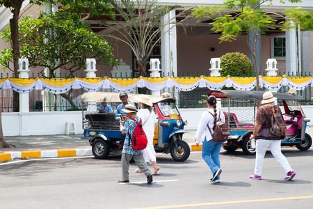 Bangkok, Thailand - April 16, 2019 : Many tourists walking on the street and Tuk Tuk in background....