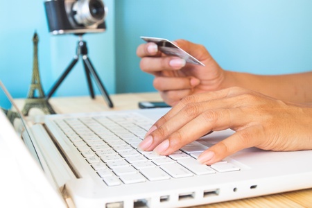 Woman's hands using laptop and credit card for booking or reservation hotel and flight for Parisの写真素材