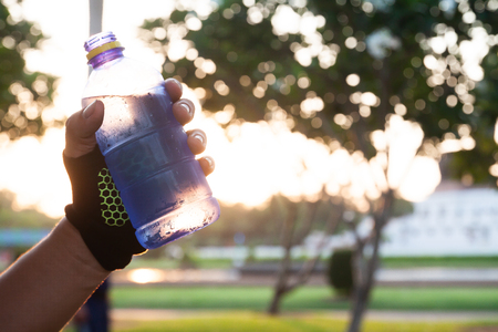 Close up man hand holding water bottle. Healthy conceptの写真素材