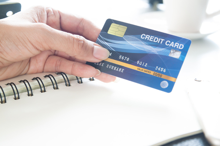 Hand holding plastic credit card. E-payment, technology and online shopping conceptの写真素材