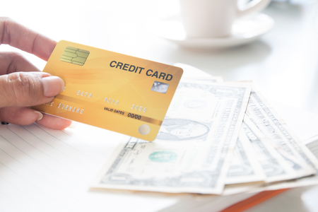 Woman hand holding plastic credit card. Business and e-payment conceptの写真素材