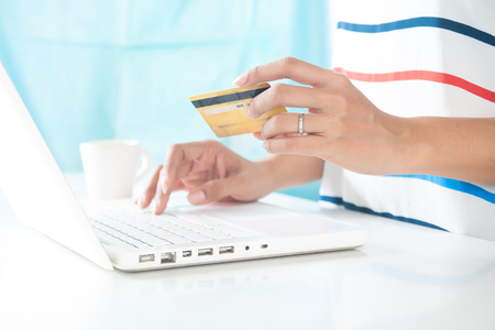 Hands holding credit card and using laptop computer. Online shopping, E-payment or internet bankingの写真素材