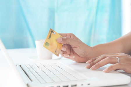 Woman hands using laptop and holding credit card. Shopping and lifestyle conceptの写真素材