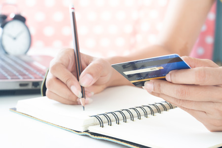 Woman hand holding plastic credit card. Business and e-payment conceptの写真素材