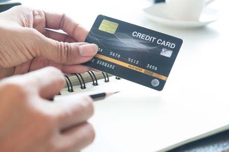 Hand holding plastic credit card. E-payment, technology and online shopping conceptの写真素材