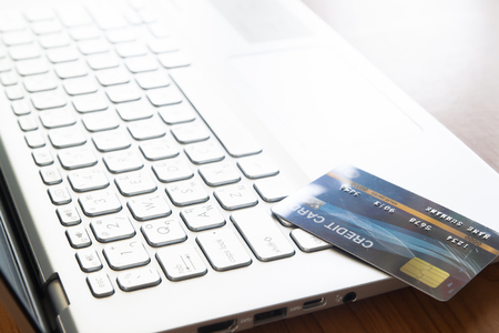 Close up credit card on laptop computer. Selective focus on keyboard. Technology, e-payment and gadget conceptの写真素材