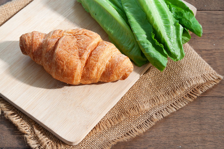 Croissant and salad vegetable. Healthy food. Breakfast conceptの写真素材