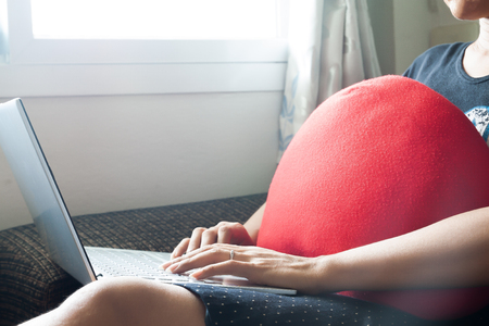 Woman relaxing at home, using laptop for shopping online or social media. Lifestyle and Healthy conceptの写真素材