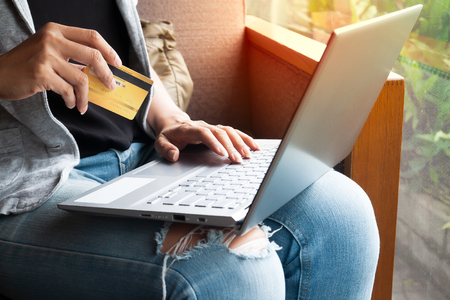 Woman hands with laptop and Credit card shopping online. Payment Transaction at Computer using Credit Cardの写真素材