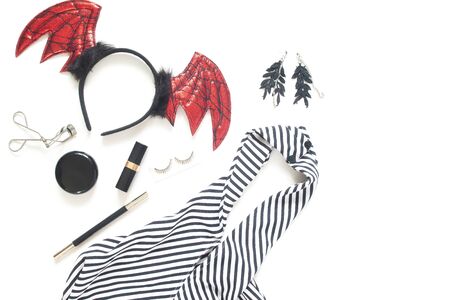Creative flat lay of woman dress and accessories for Halloween party on white background with copy space.の写真素材
