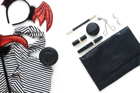 Creative flat lay of woman dress and accessories for Halloween party on white background. の写真素材