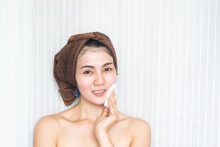 Asian woman cleansing her face. Beauty and skincare conceptの写真素材